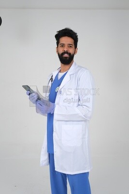 Saudi man wearing a medical coat and a stethoscope, using his mobile, white background, medicine and health care, Saudi model