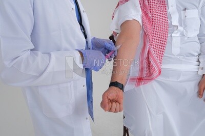 Saudi man wearing a medical coat and a stethoscope, holding a medical needle, giving it to the patient, white background, medicine and health care, Saudi model