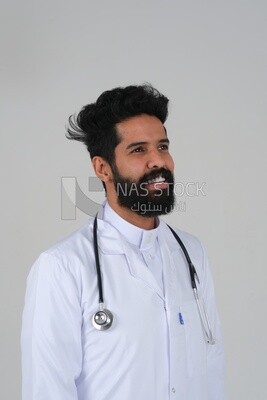 Saudi man wearing a medical coat and a stethoscope, white background, medicine and health care, Saudi model
