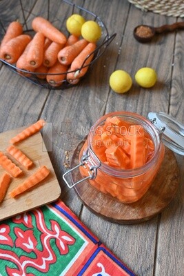 Jar of pickled carrots, a bowl with carrots and lemon, Egyptian pickles, Arab restaurants