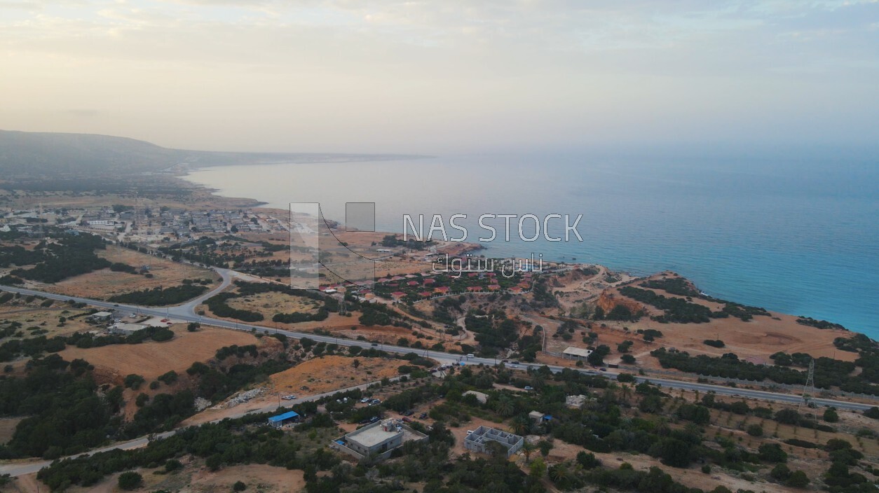 drone footage shows an overview of Ra&#39;s Al Hilal village with sea, landmarks in Libya