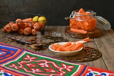 Jar of pickled carrots, a bowl with carrots and lemon, Egyptian pickles, Arab restaurants