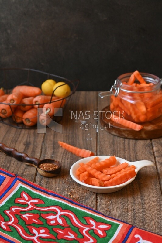 Jar of pickled carrots, a bowl with carrots and lemon, Egyptian pickles, Arab restaurants