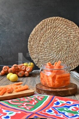 Jar of pickled carrots, a bowl with carrots and lemon, Egyptian pickles, Arab restaurants