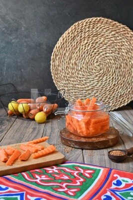 Jar of pickled carrots, a bowl with carrots and lemon, Egyptian pickles, Arab restaurants