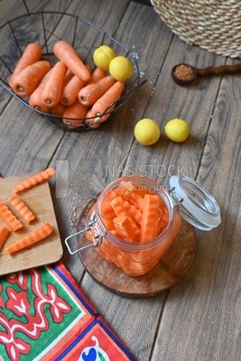Jar of pickled carrots, a bowl with carrots and lemon, Egyptian pickles, Arab restaurants
