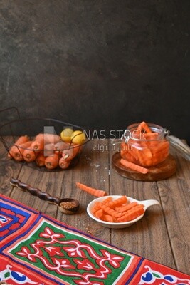 Jar of pickled carrots, a bowl with carrots and lemon, Egyptian pickles, Arab restaurants