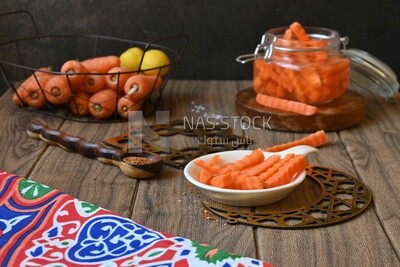 Jar of pickled carrots, a bowl with carrots and lemon, Egyptian pickles, Arab restaurants