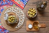 Bowl of Pickled green olives, jar of pickled green olives, Egyptian pickles, Arab restaurants