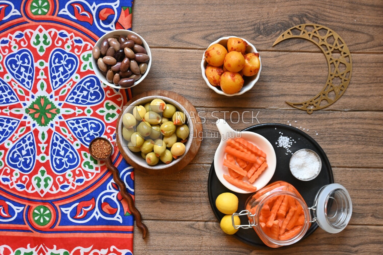 Jar of pickled carrots, a bowl of Pickled black olives, a bowl of Pickled green olives, bowl of Pickled lemon, Egyptian pickles, Arab restaurants