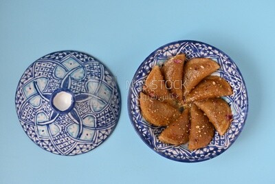 Plate of Qatayef with nuts, oriental Arabic sweets, Ramadan sweets