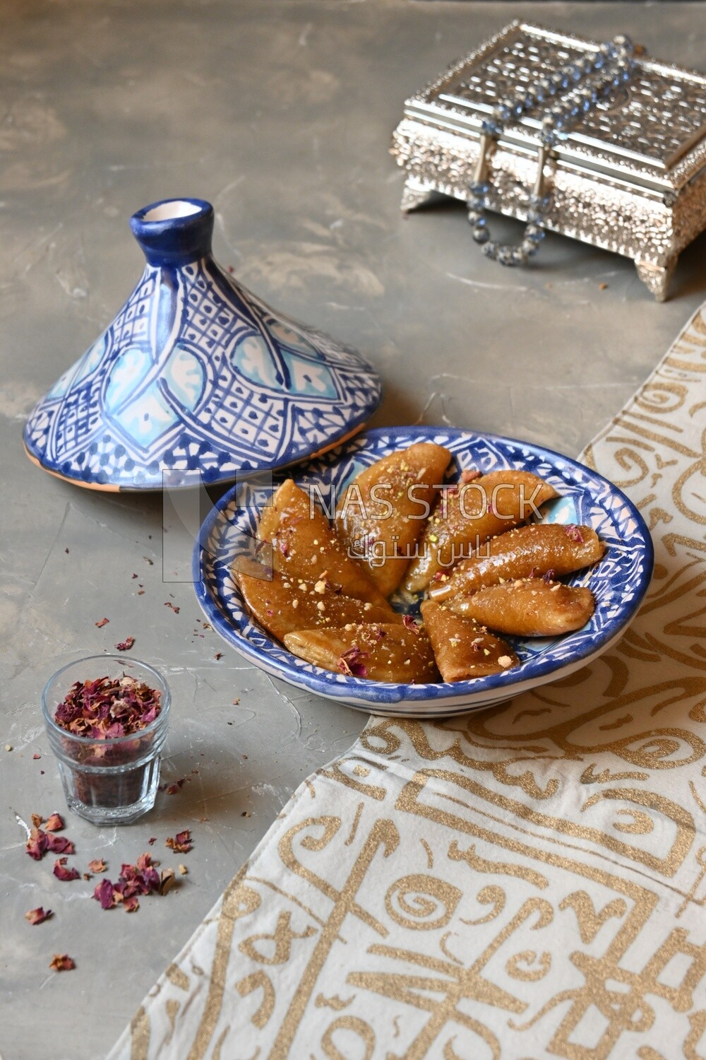 Plate of Qatayef with nuts, oriental Arabic sweets, Ramadan sweets