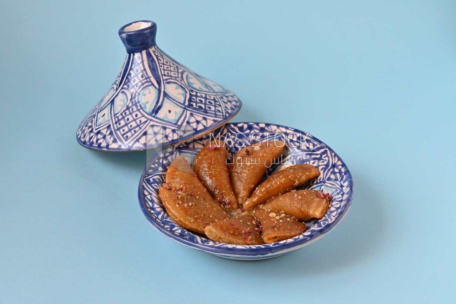 Plate of Qatayef with nuts, oriental Arabic sweets, Ramadan sweets
