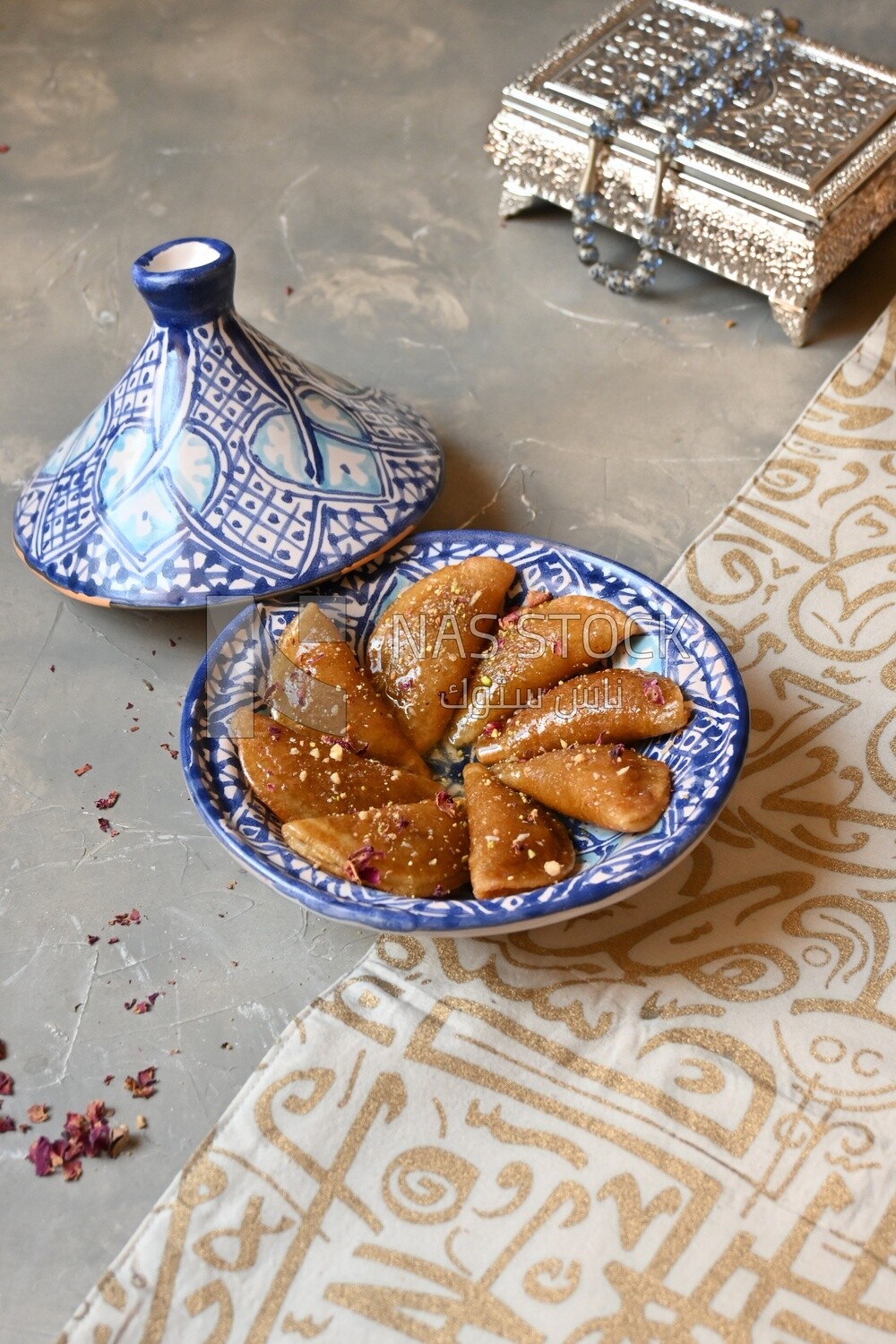Plate of Qatayef with nuts, oriental Arabic sweets, Ramadan sweets