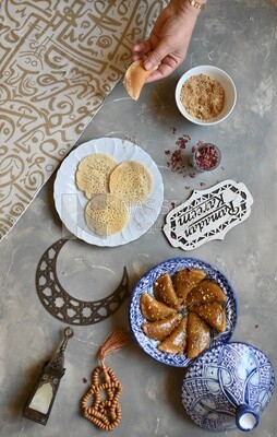 Plate of Qatayef with nuts, oriental Arabic sweets, Ramadan sweets