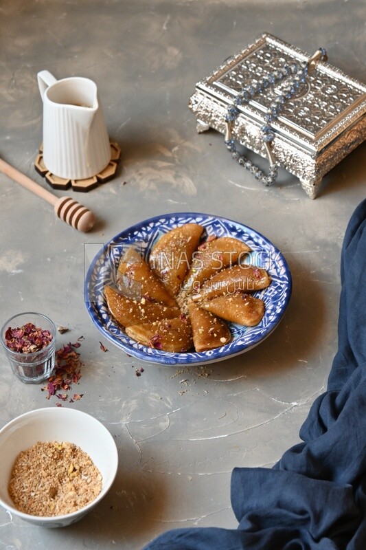 Plate of Qatayef with nuts, oriental Arabic sweets, Ramadan sweets