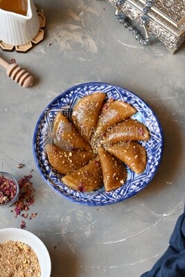 Plate of Qatayef with nuts, oriental Arabic sweets, Ramadan sweets