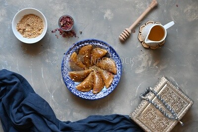 Plate of Qatayef with nuts, oriental Arabic sweets, Ramadan sweets