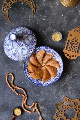 Plate of Qatayef with nuts, oriental Arabic sweets, Ramadan sweets