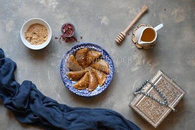 Plate of Qatayef with nuts, oriental Arabic sweets, Ramadan sweets