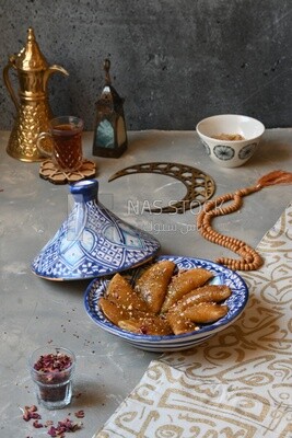 Plate of Qatayef with nuts, oriental Arabic sweets, Ramadan sweets