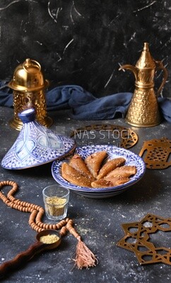 Plate of Qatayef with nuts, oriental Arabic sweets, Ramadan sweets