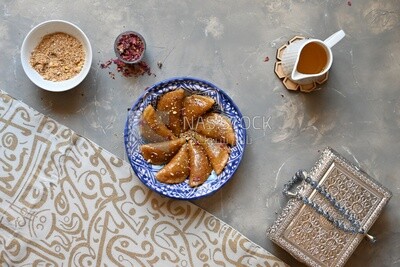 Plate of Qatayef with nuts, oriental Arabic sweets, Ramadan sweets