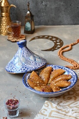 Plate of Qatayef with nuts, oriental Arabic sweets, Ramadan sweets