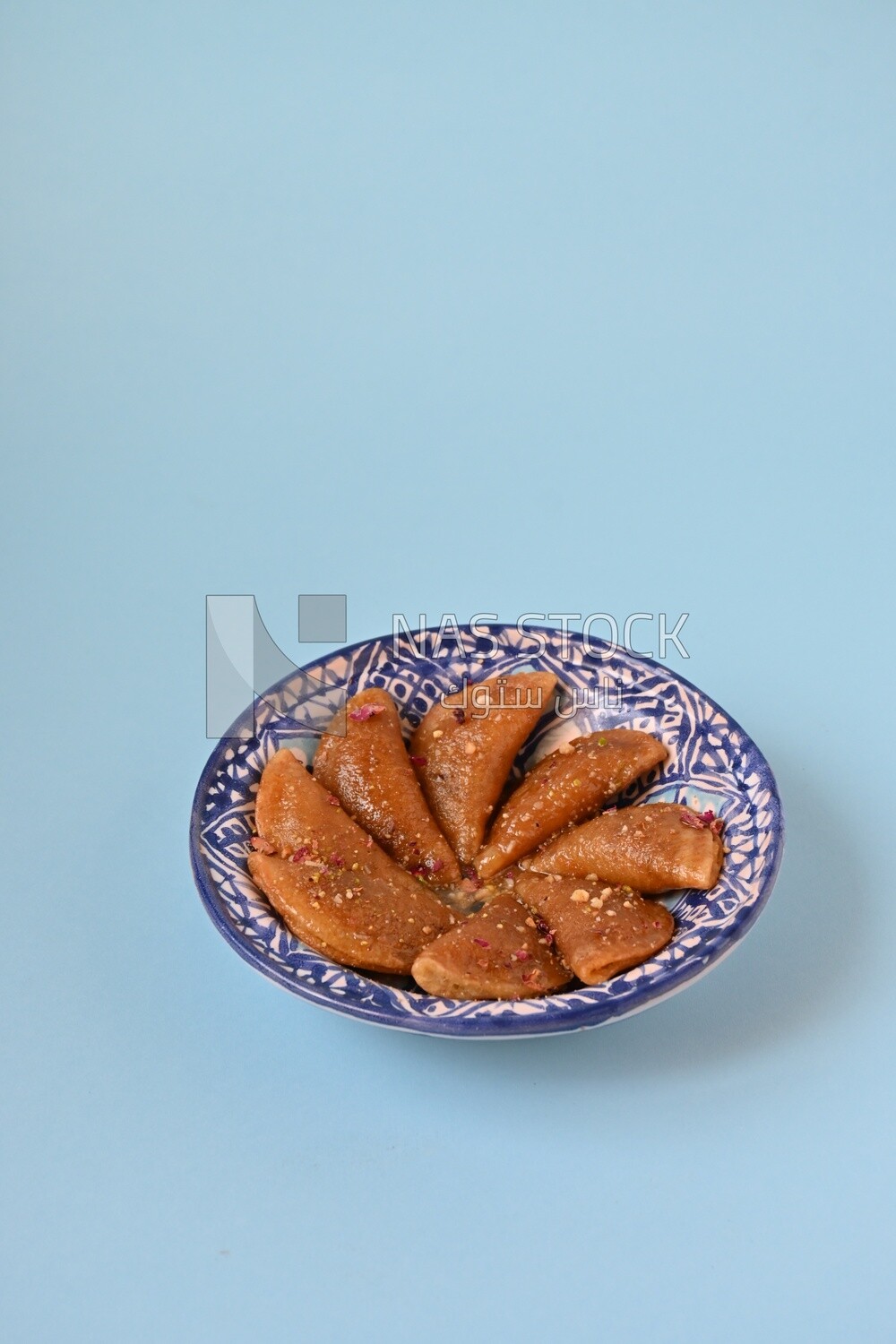 Plate of Qatayef with nuts, oriental Arabic sweets, Ramadan sweets