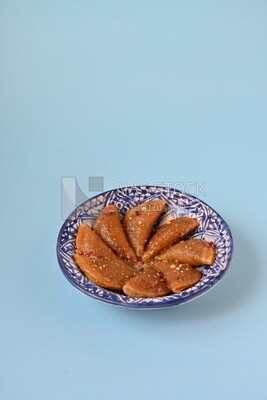 Plate of Qatayef with nuts, oriental Arabic sweets, Ramadan sweets