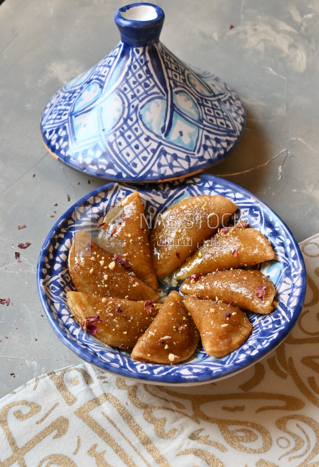 Plate of Qatayef with nuts, oriental Arabic sweets, Ramadan sweets