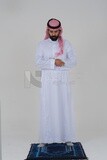 Saudi man wearing a white thobe and shemagh praying on the prayer rug, praying to god, Islam and worship, white background, Saudi model