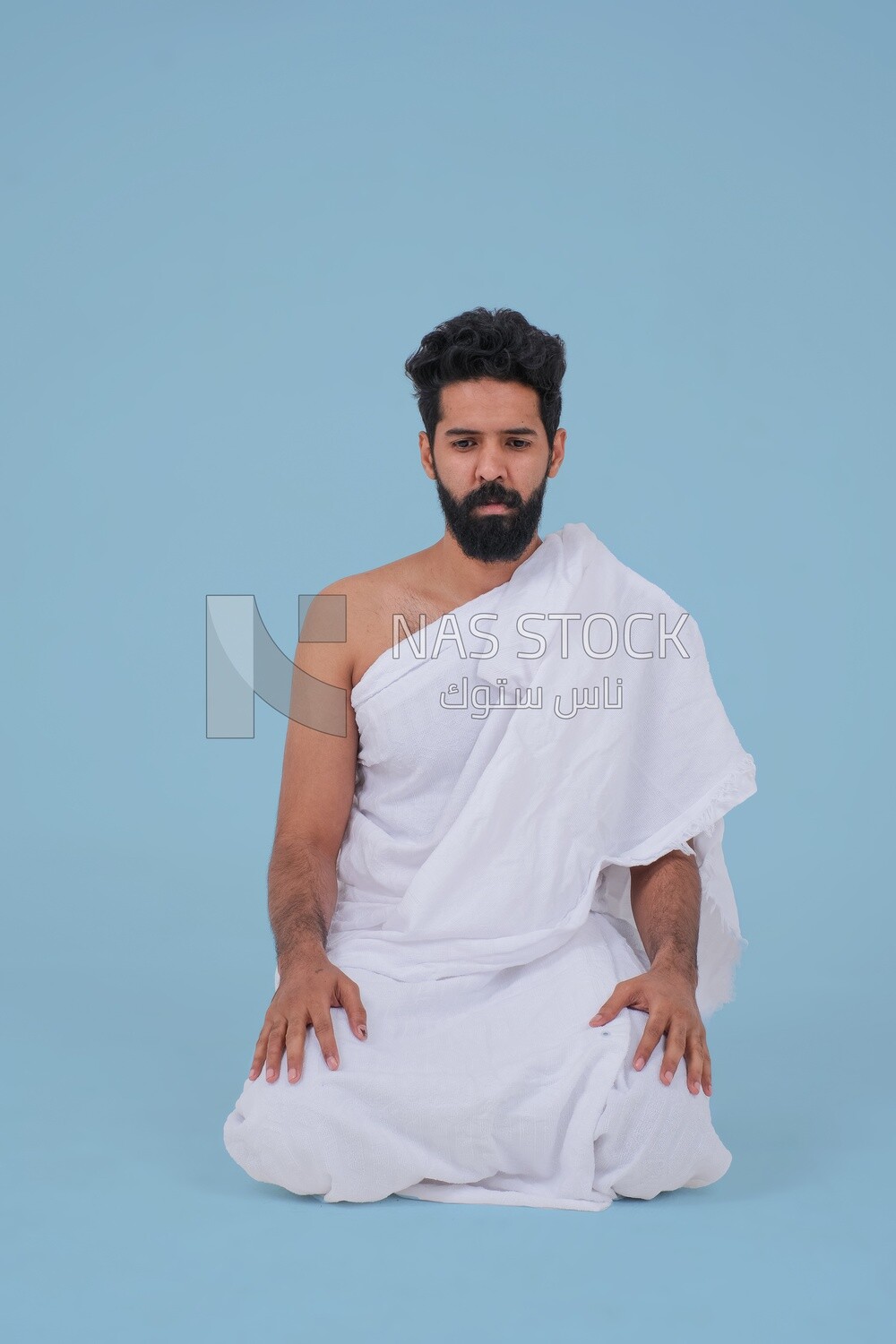 Saudi man wearing the Ihram dress, praying on the prayer rug, praying to god, Islam and worship, performing Hajj and Umrah, remembrances and supplications, Saudi model