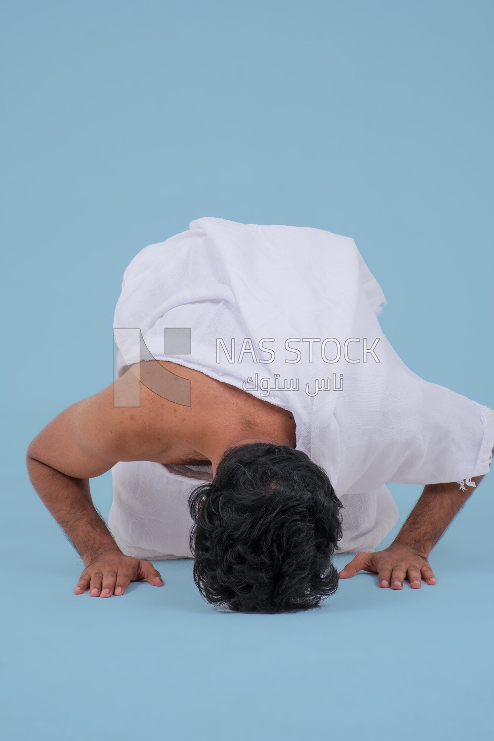 Saudi man wearing the Ihram dress, praying on the prayer rug, praying to god, Islam and worship, performing Hajj and Umrah, remembrances and supplications, Saudi model