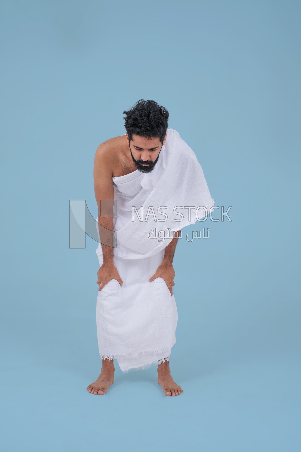 Saudi man wearing the Ihram dress, praying on the prayer rug, praying to god, Islam and worship, performing Hajj and Umrah, remembrances and supplications, Saudi model