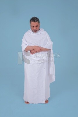 Saudi man wearing the Ihram dress, praying on the prayer rug, praying to god, Islam and worship, performing Hajj and Umrah, remembrances and supplications, Saudi model