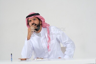 Saudi man wearing a white thobe and shemagh takes a deep breath from a cigarette, tobacco addiction, cigarette addiction, harmful and toxic substance abuse, harmful behavioral habits, no smoking, Saud