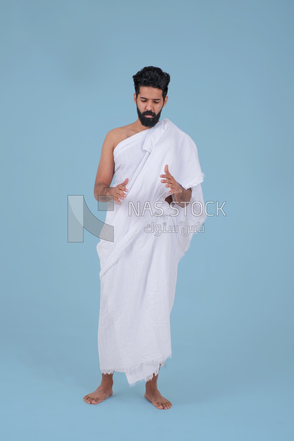 Saudi man wearing the Ihram dress, praying on the prayer rug, praying to god, Islam and worship, performing Hajj and Umrah, remembrances and supplications, Saudi model