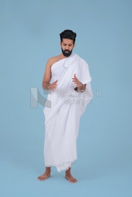 Saudi man wearing the Ihram dress, praying on the prayer rug, praying to god, Islam and worship, performing Hajj and Umrah, remembrances and supplications, Saudi model