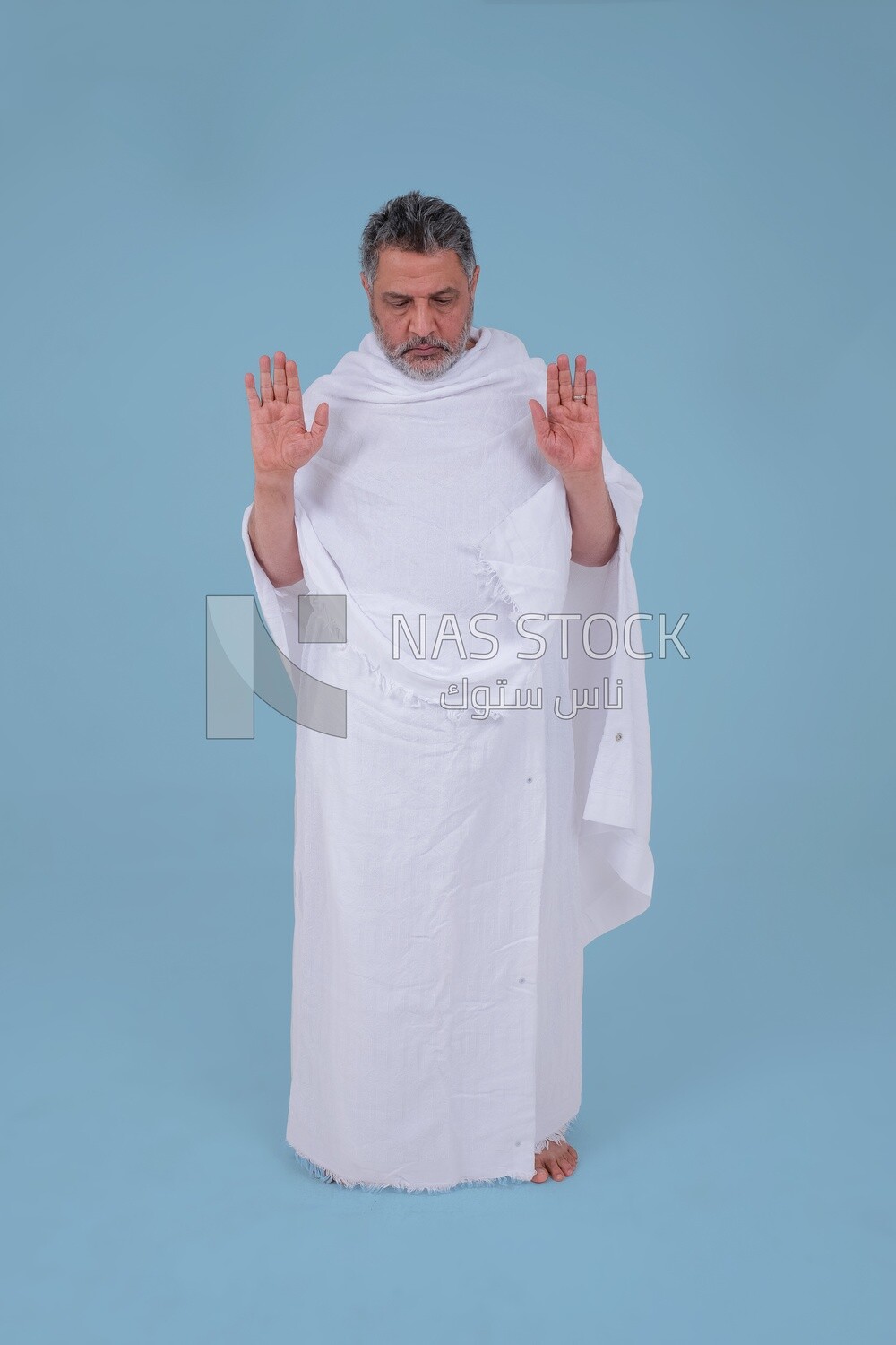 Saudi man wearing the Ihram dress, praying on the prayer rug, praying to god, Islam and worship, performing Hajj and Umrah, remembrances and supplications, Saudi model