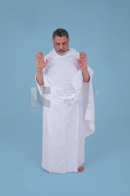 Saudi man wearing the Ihram dress, praying on the prayer rug, praying to god, Islam and worship, performing Hajj and Umrah, remembrances and supplications, Saudi model