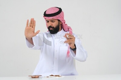 Saudi man fights against the smoking habit, gestures indicating stopping, tobacco addiction, cigarette addiction, harmful and toxic substance abuse, harmful behavioral habits, no smoking, Saudi model