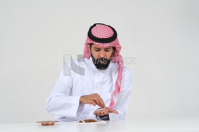 Saudi man wrapping cigarettes with his hands, tobacco addiction, cigarette addiction, harmful and toxic substance abuse, harmful behavioral habits, no smoking, Saudi model