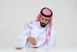 Saudi man wrapping cigarettes with his hands, tobacco addiction, cigarette addiction, harmful and toxic substance abuse, harmful behavioral habits, no smoking, Saudi model