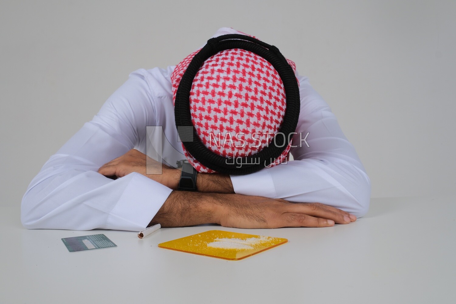 Saudi man sitting in front of many types of toxic substances, tobacco addiction, cigarette addiction, harmful and toxic substance abuse, harmful behavioral habits, no smoking, Saudi model