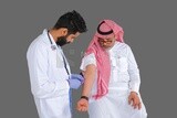 Saudi man wear medical coats and gloves and give Saudi patient injections, the concept of medicine and health care, and receive vaccinations in health centers, Saudi model