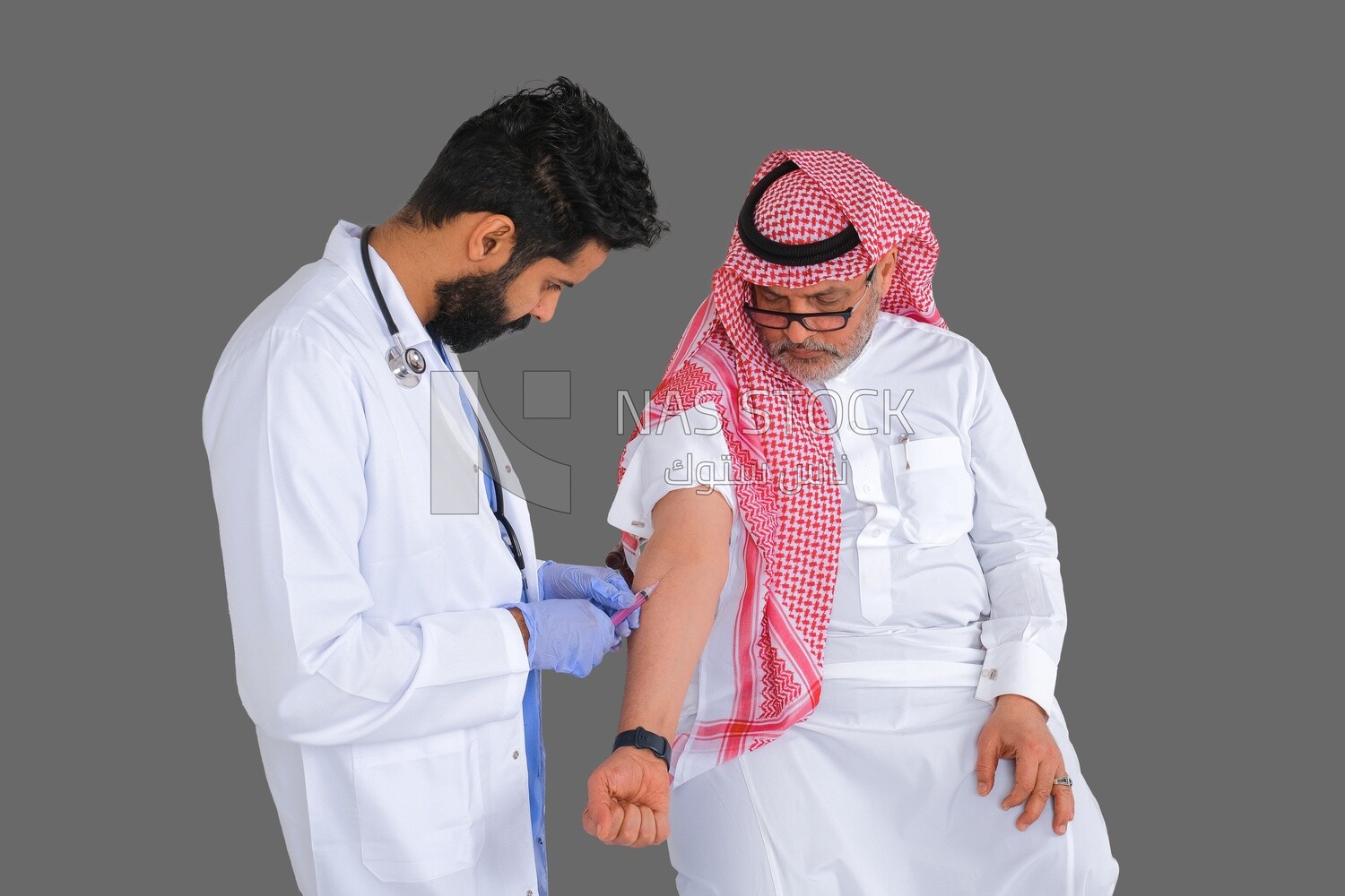 Saudi man wear medical coats and gloves and give Saudi patient injections, the concept of medicine and health care, and receive vaccinations in health centers, Saudi model