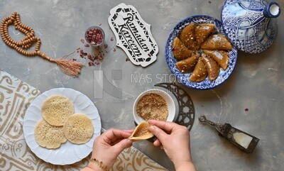 Hand stuffing Qatayef, nuts, oriental Arabic sweets, Ramadan sweets