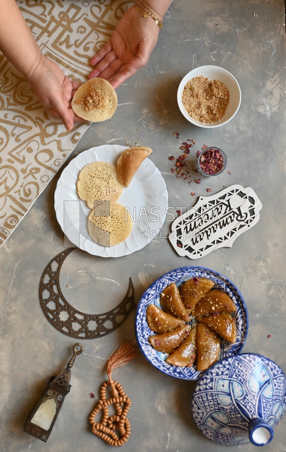 Hand stuffing Qatayef, nuts, oriental Arabic sweets, Ramadan sweets