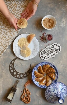 Hand stuffing Qatayef, nuts, oriental Arabic sweets, Ramadan sweets